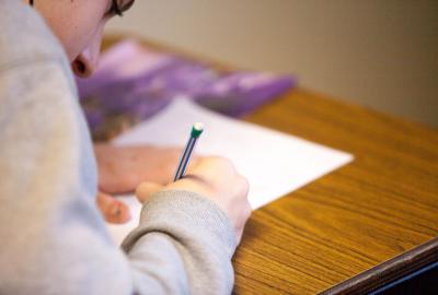 hombre estudiando con computadora y cuaderno